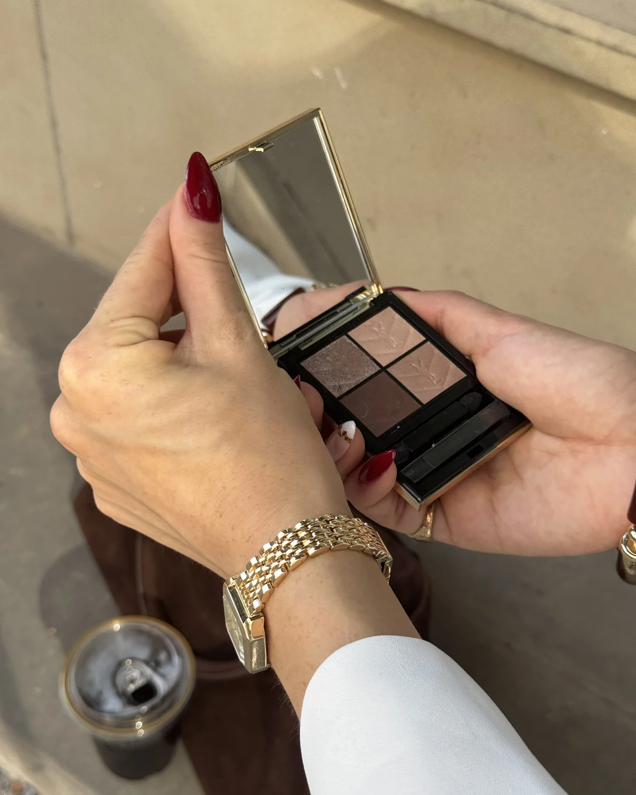 A makeup palette photographed in warm natural light
